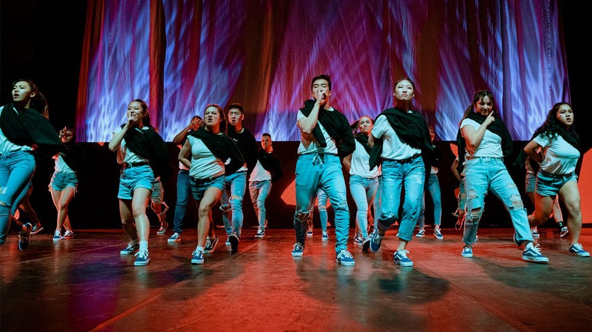Image of BC students dancing and singing with passion