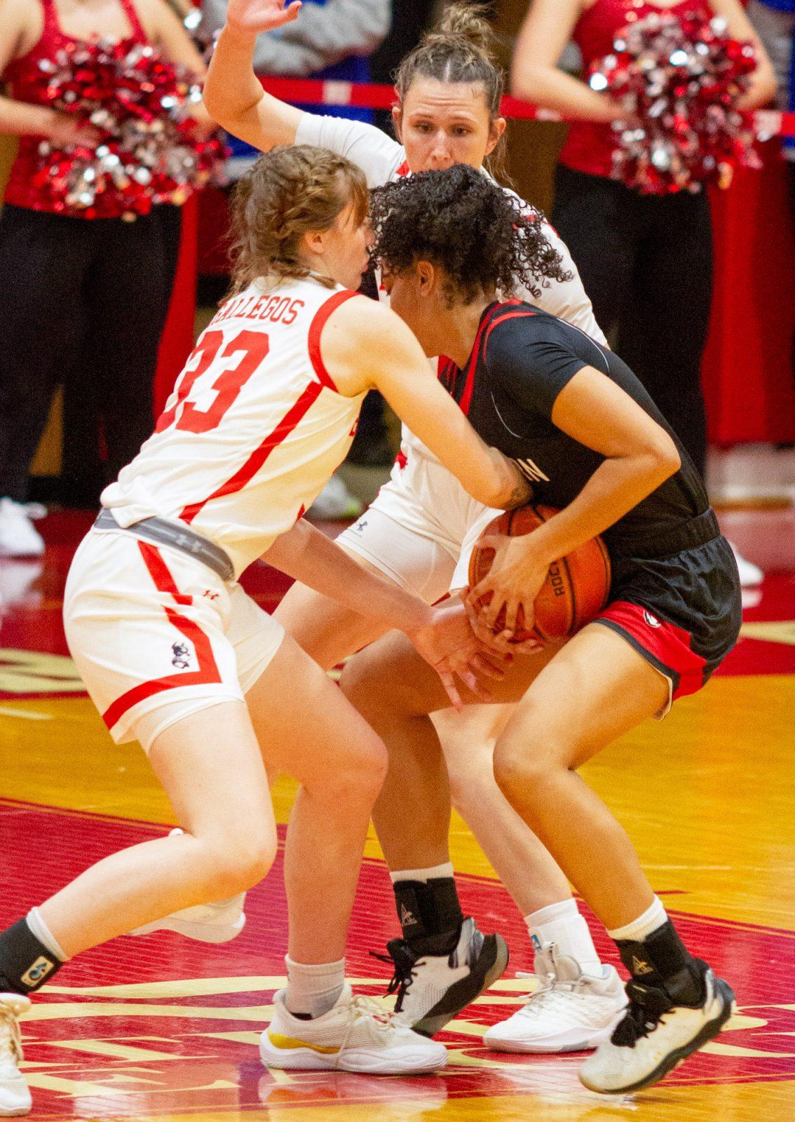 Freshman forward Inez Gallegos (33) battles a Northeastern player for the ball during the women’s basketball game on Nov. 4. The Boston University women’s basketball team beat Rider University on Sunday. CLAIRE GUEST/DFP PHOTOGRAPHER 

