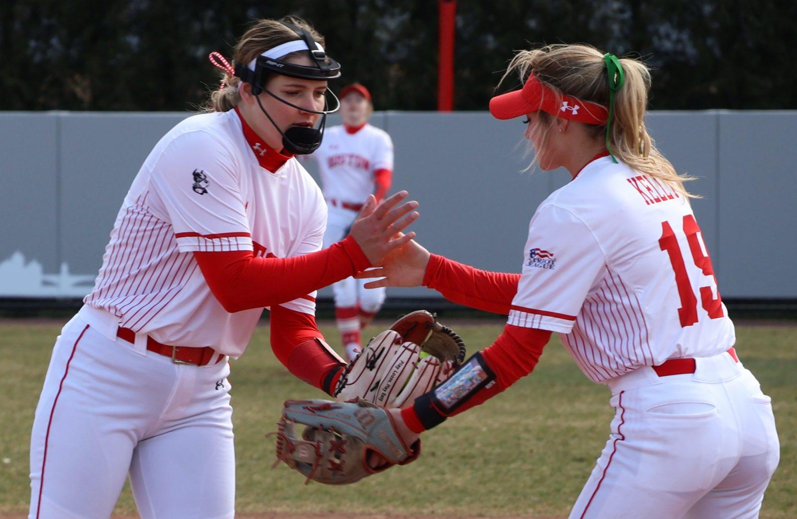 Graduate pitcher Lizzy Avery (27) shakes hands with senior Raegan Kelly (19) during a game against Yale University in March. The Terriers shut out Bucknell University 7-0 on Saturday. 
ZOE KU/DFP PHOTOGRAPHER