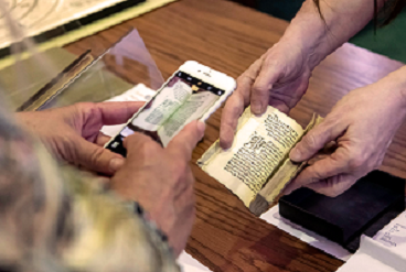 Researcher photographing book