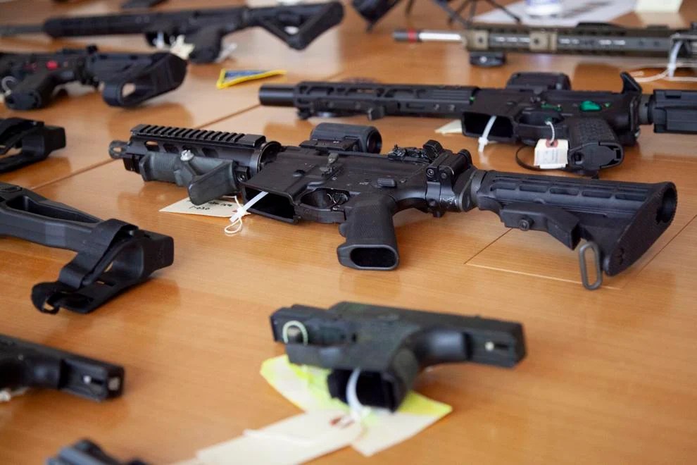 Ghost guns and ghost gun parts are displayed on a table in Attorney General Andrea Campbell’s office at a press event she hosted on July 11, 2023.