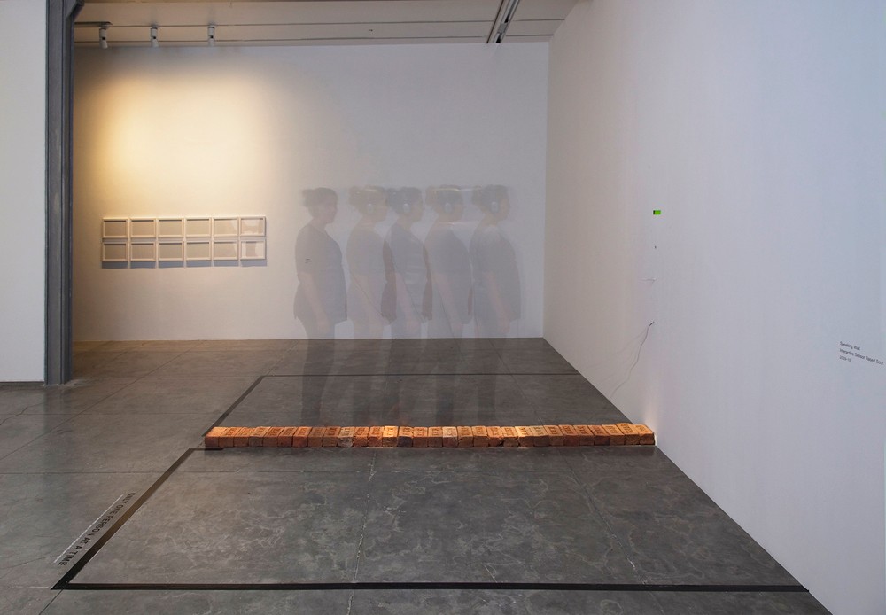 Shilpa Gupta, 'Speaking Wall,' 2009–10 interactive sensor-based sound installation: LCD screen, bricks, headphones, 8:00 interaction loop, 118 x 118 x 118 in.