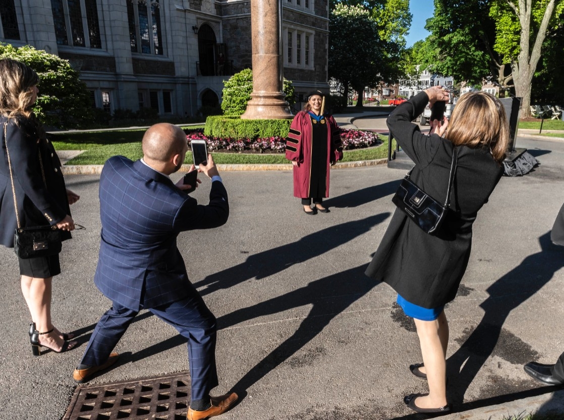 Family taking photos of a graduate Family taking photos of a graduate