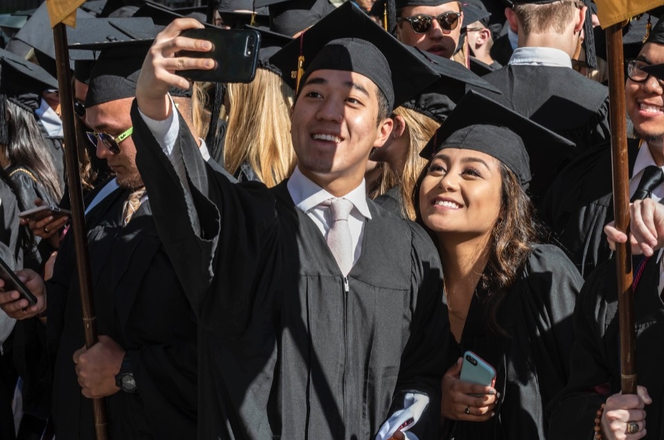 Graduates taking selfies Graduates taking selfies