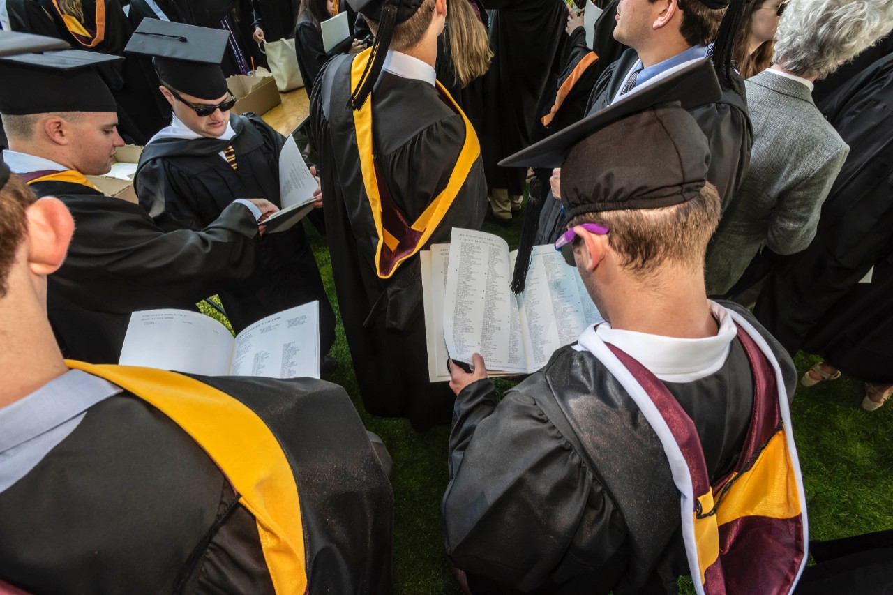 Members of the Class of 2018 consult their programs Members of the Class of 2018 consult their programs