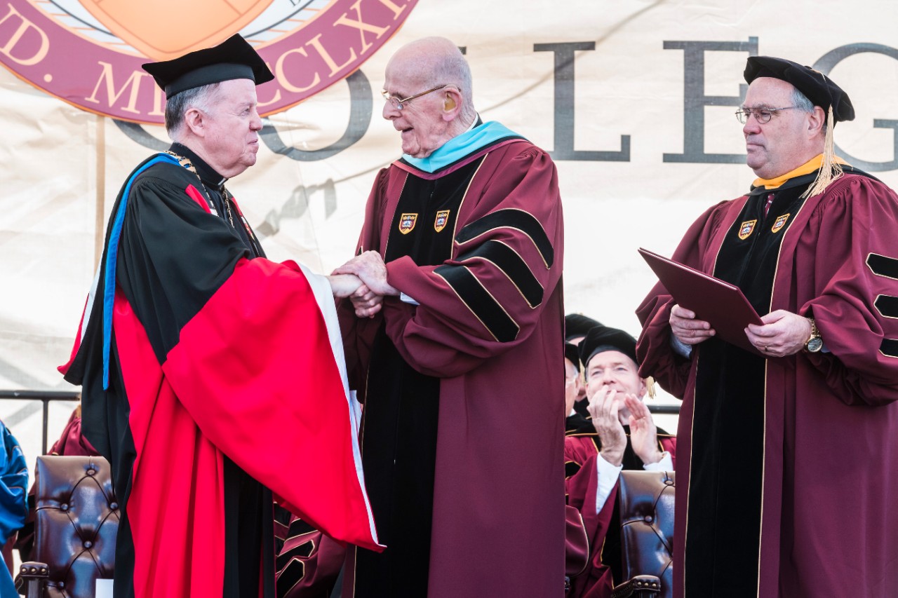 University President William P. Leahy, S.J., congratulates honorary degree recipient and longtime BC administrator Joseph P. Duffy, S.J.,'50, MA'51, STL'58; as BC Board of Trustees Chair Peter K. Markell '77 looks on University President William P. Leahy, S.J., congratulates honorary degree recipient and longtime BC administrator Joseph P. Duffy, S.J.,'50, MA'51, STL'58; as BC Board of Trustees Chair Peter K. Markell '77 looks on