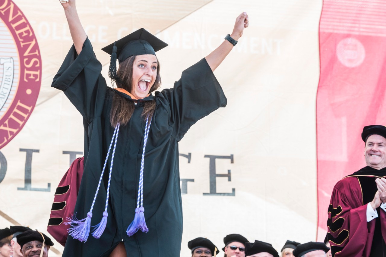 Student cheers after receiving diploma Student cheers after receiving diploma