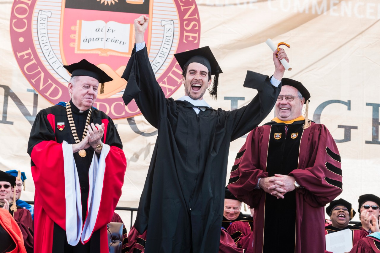 Student cheers after receiving diploma Student cheers after receiving diploma
