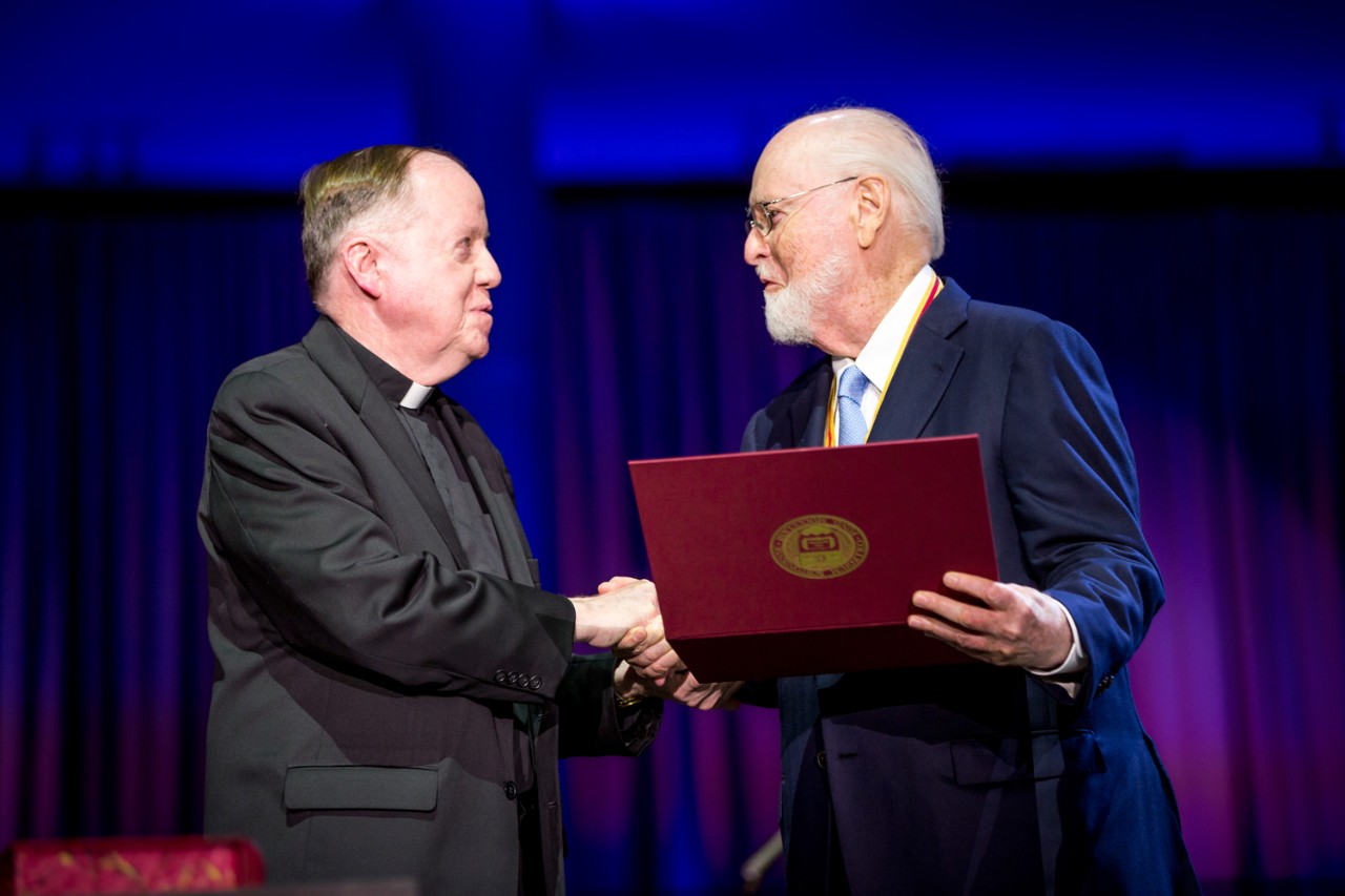 Boston College President William P. Leahy, S.J. congratulates President's Medal for Excellence recipient John Williams, one of America’s most successful composers for film and the concert stage, and a longtime friend to the University. (Caitlin Cunningham) Boston College President William P. Leahy, S.J. congratulates President's Medal for Excellence recipient John Williams, one of America’s most successful composers for film and the concert stage, and a longtime friend to the University. (Caitlin Cunningham)