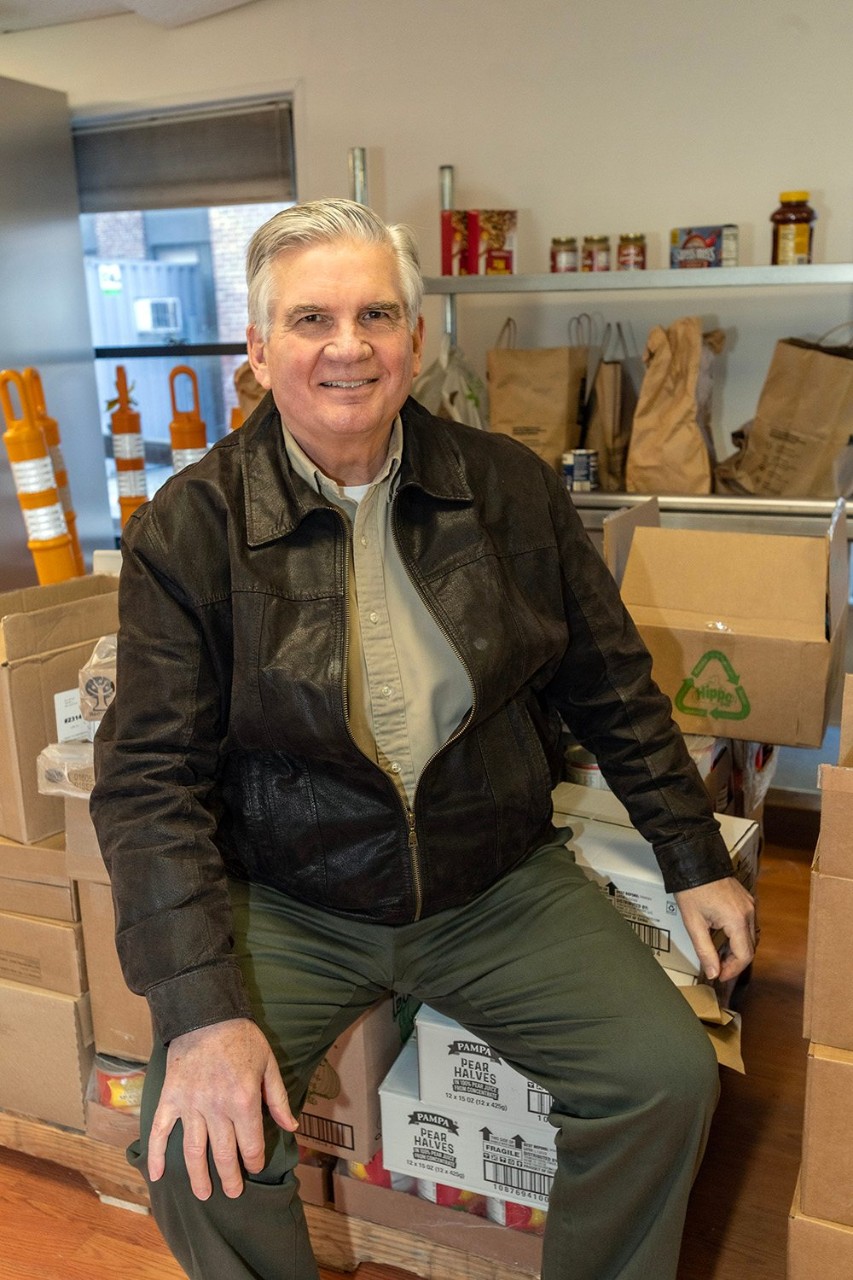 Tom MacDonald sitting in a food pantry