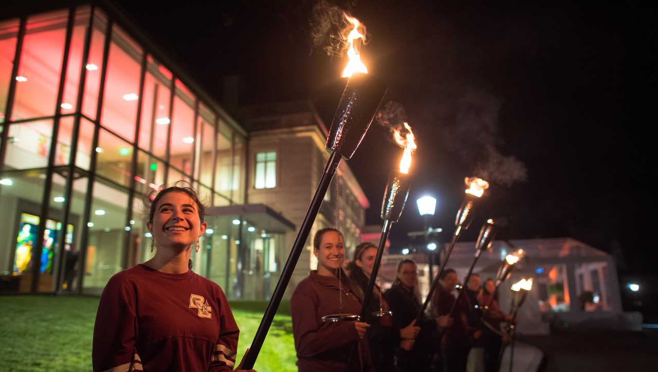 Students bearing torches to symbolize the 'Light the World' effort. Students bearing torches to symbolize the 'Light the World' effort.