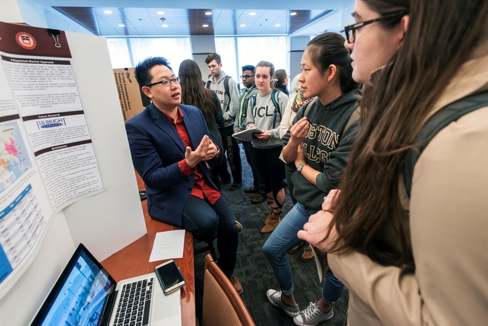 Undergraduate Poster Session for the Humanities in the Reading Room of O'Neill Library. Richard Balagtas A&S '16 explains his project to Allicen Dichiara A&S '16, graduate student Rachael Tully, Lauren Lin A&S '18, and Kejs Aliko A&S '18. Undergraduate Poster Session for the Humanities in the Reading Room of O'Neill Library. Richard Balagtas A&S '16 explains his project to Allicen Dichiara A&S '16, graduate student Rachael Tully, Lauren Lin A&S '18, and Kejs Aliko A&S '18.
