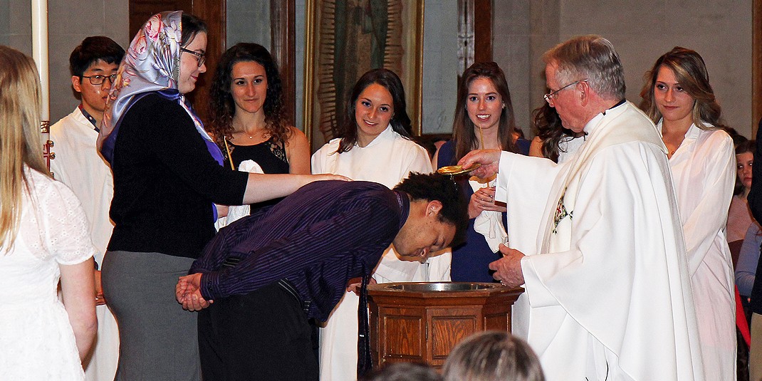 Sophomore Stephen Porritt receiving the Sacrament of Baptism during the RCIA ceremony held on April 10.
