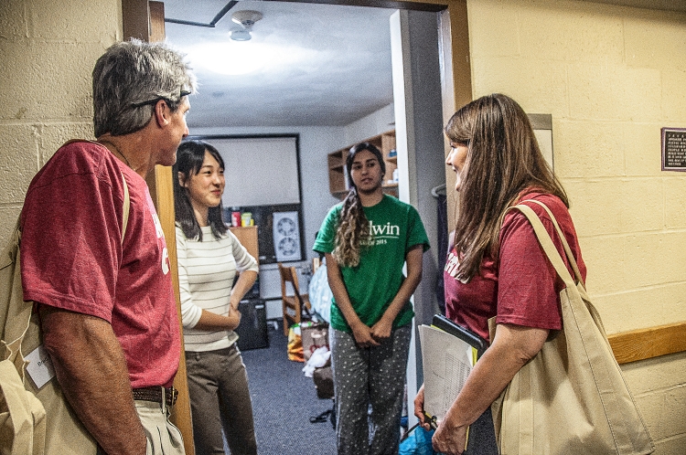 Athletics Director Brad Bates and Office of Residential Life Associate Director Dorrie Siqueiros talking to students