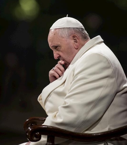 Pope Francis sitting sideways contemplating