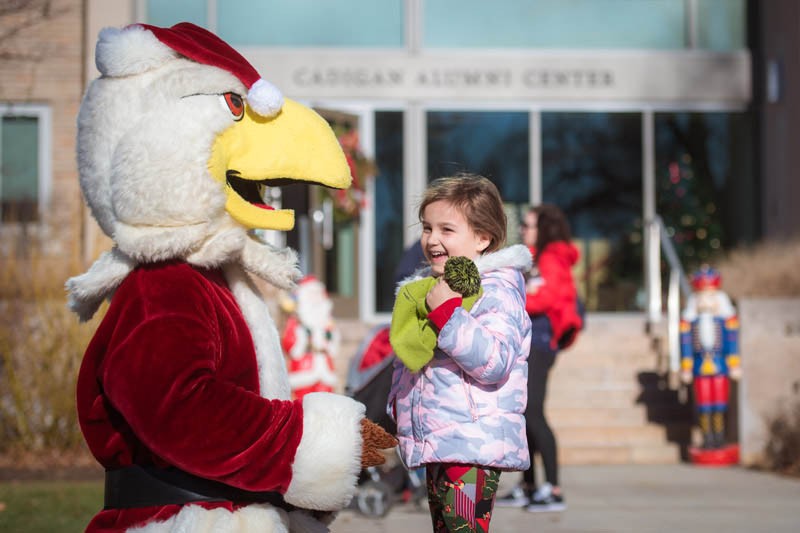 Baldwin and a child interacting outside of Cadigan Alumni Center