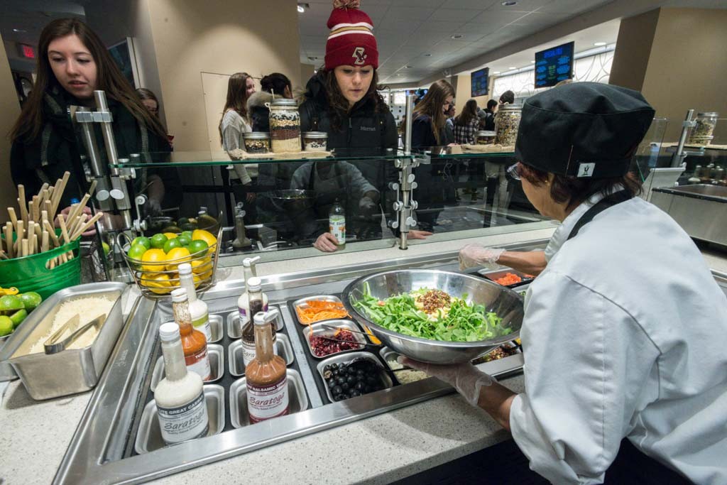 students at salad bar with dining staff