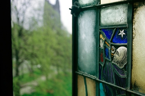 Stained glass: man looking through telescope