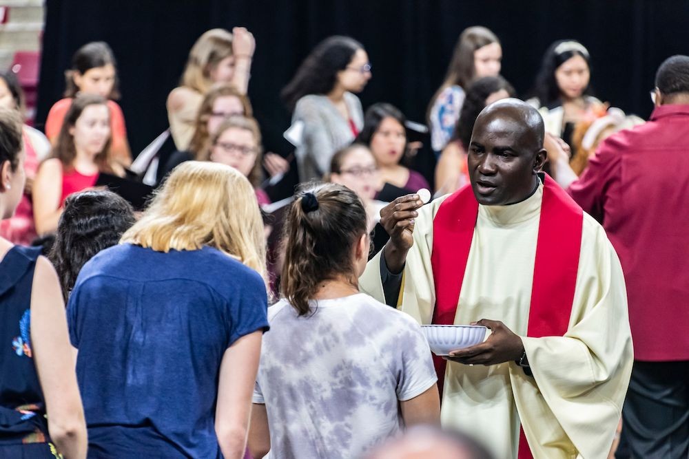 A student receiving a blessing