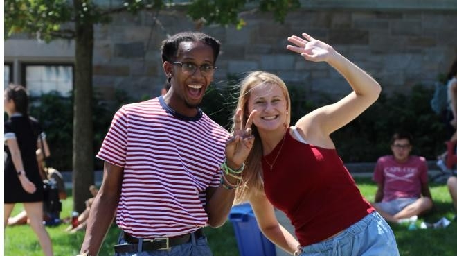 two students playing cornhole