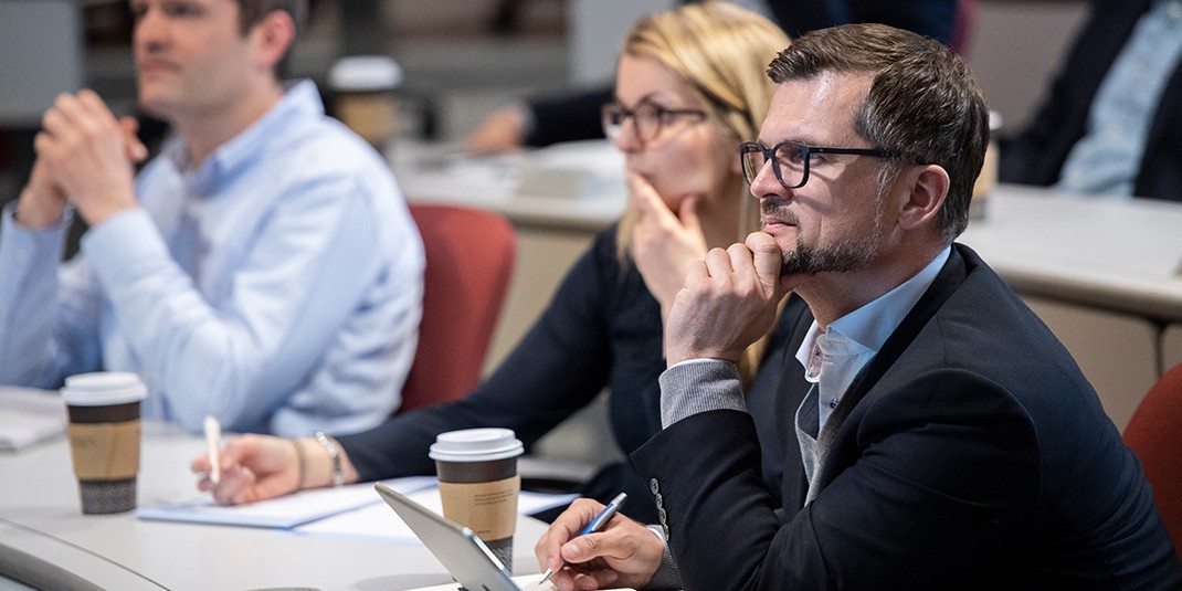 Executives from TeamBank listen to the presentation.