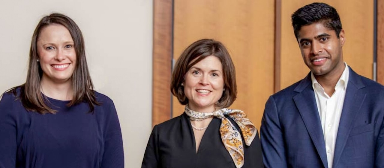 Christine De Forge in dark dress, Katherine Gregory in dark dress, pearl necklace and patterned scarf, and Guru Shan in blue jacket and white dress shirt