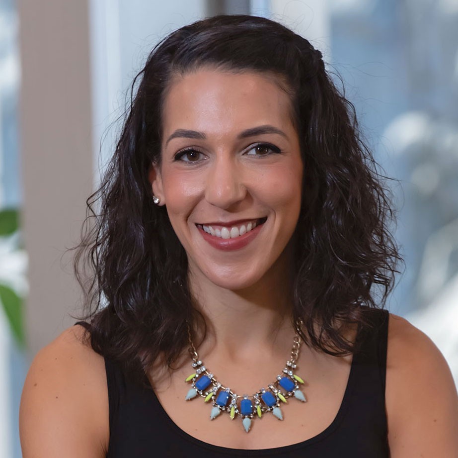 Nadia Abuelezam in black tank top with blue and green necklace
