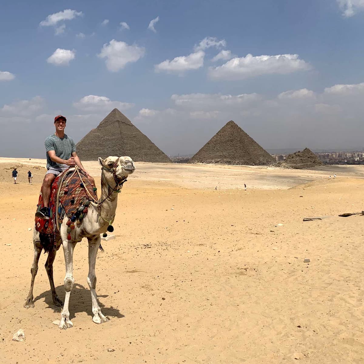 Evan Fagan '22 surveys the pyramids of Giza atop a camel.
