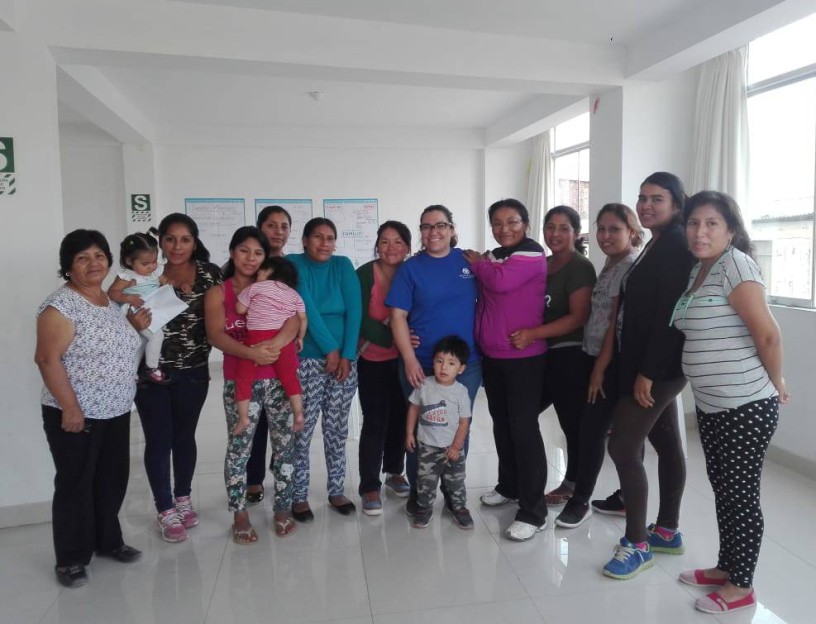 group of women standing with their children