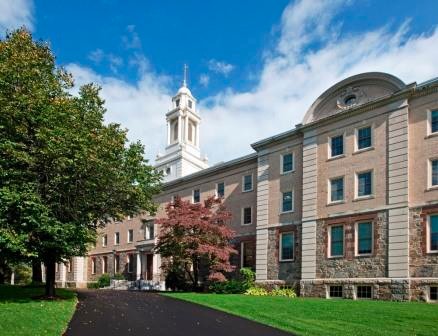 Simboli Hall with bright green grass and blue sky