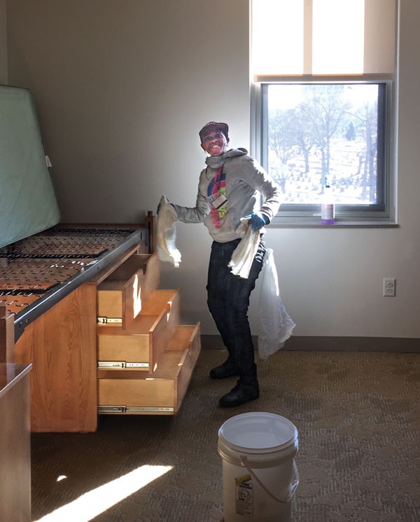 Facilities staffer cleaning