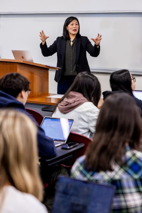 Arissa Oh speaks animatedly to a class of students