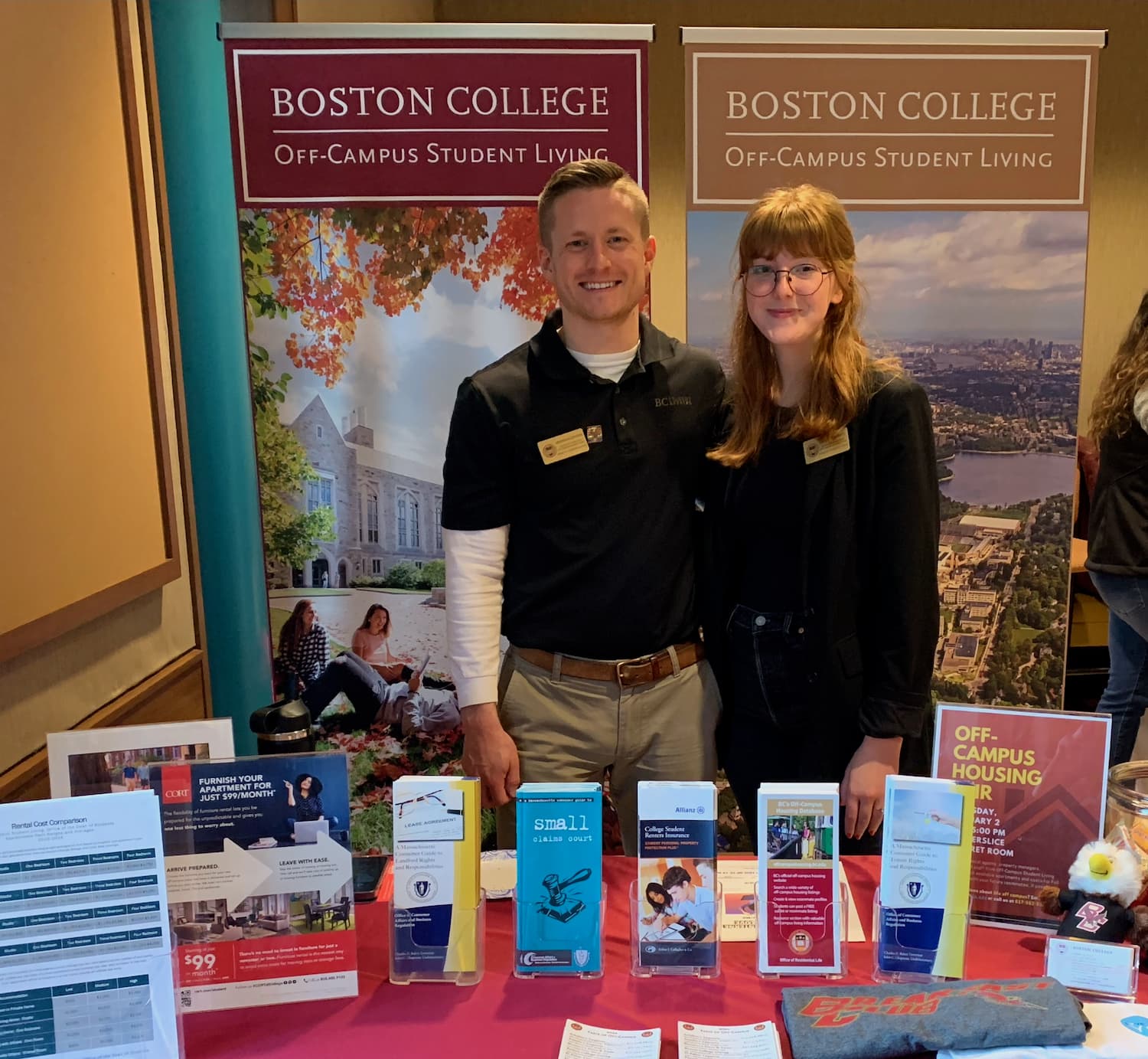 Two people standing behind a table