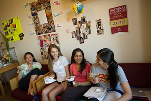 students talking in a dorm room