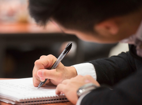Student writing in notebook