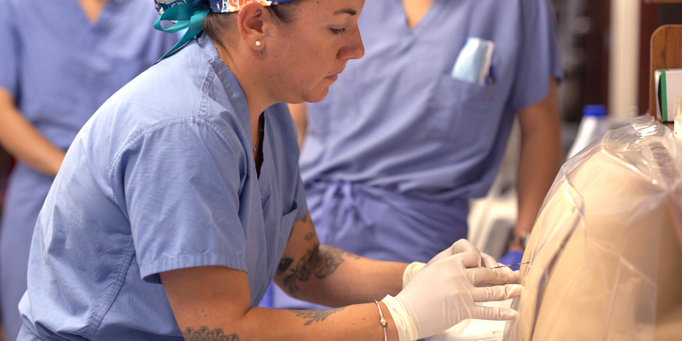 August 1, 2022 -- Allan Thomas, Assistant Professor of the Practice and Assistant Program Director of Nurse Anesthesia, teaching a full-gear epidural simulation at Boston College's Connell School of Nursing in Maloney Hall.