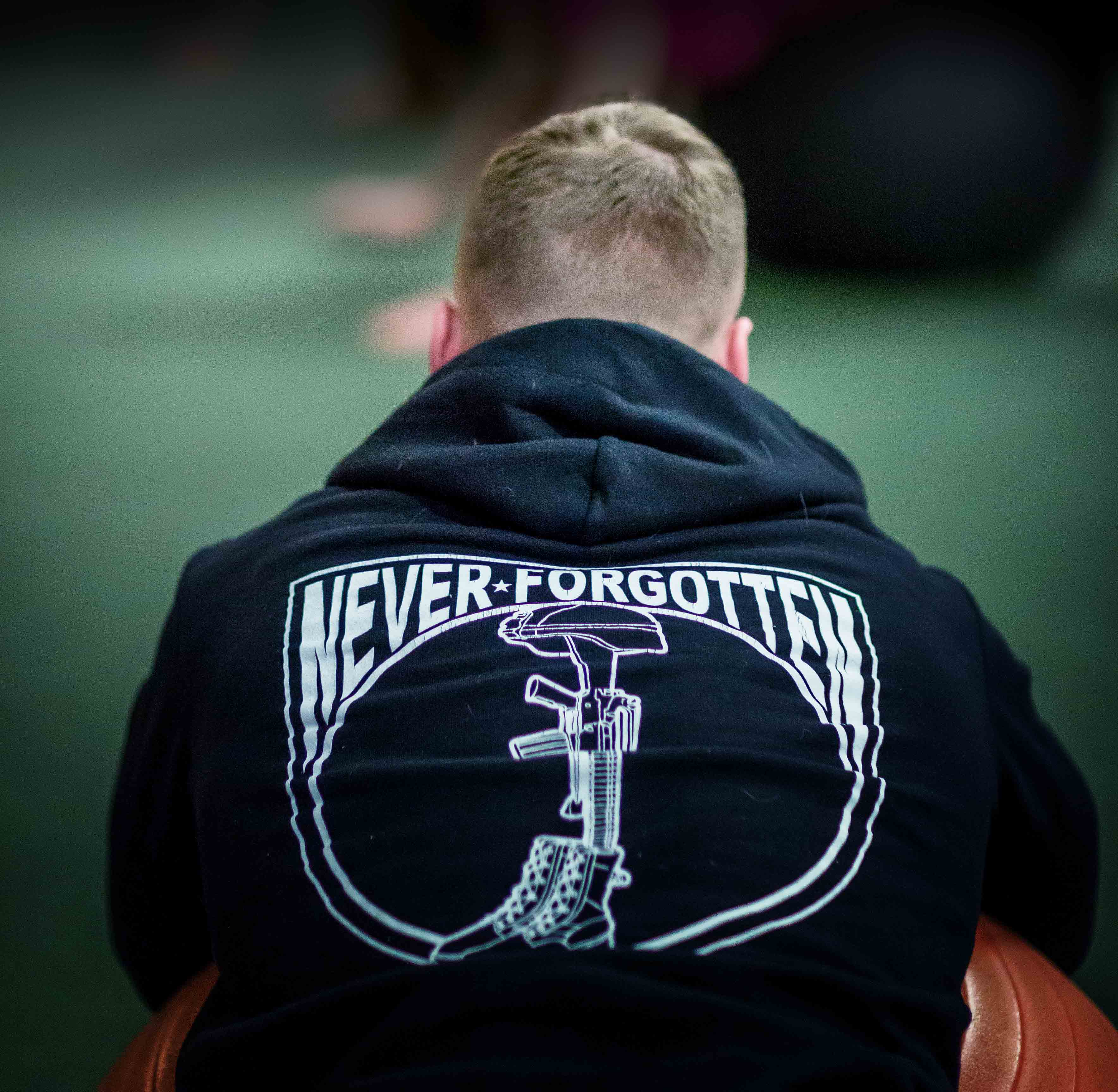 Participant in Collegiate Warrior program at Boston College wearing a black sweatshit with the words "Never Forgotten" on the back