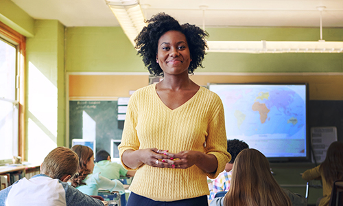 522138534 Portrait of a young teacher with her learners in the background