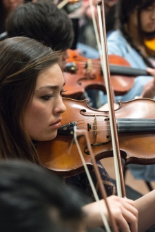 A music department student playing the violin