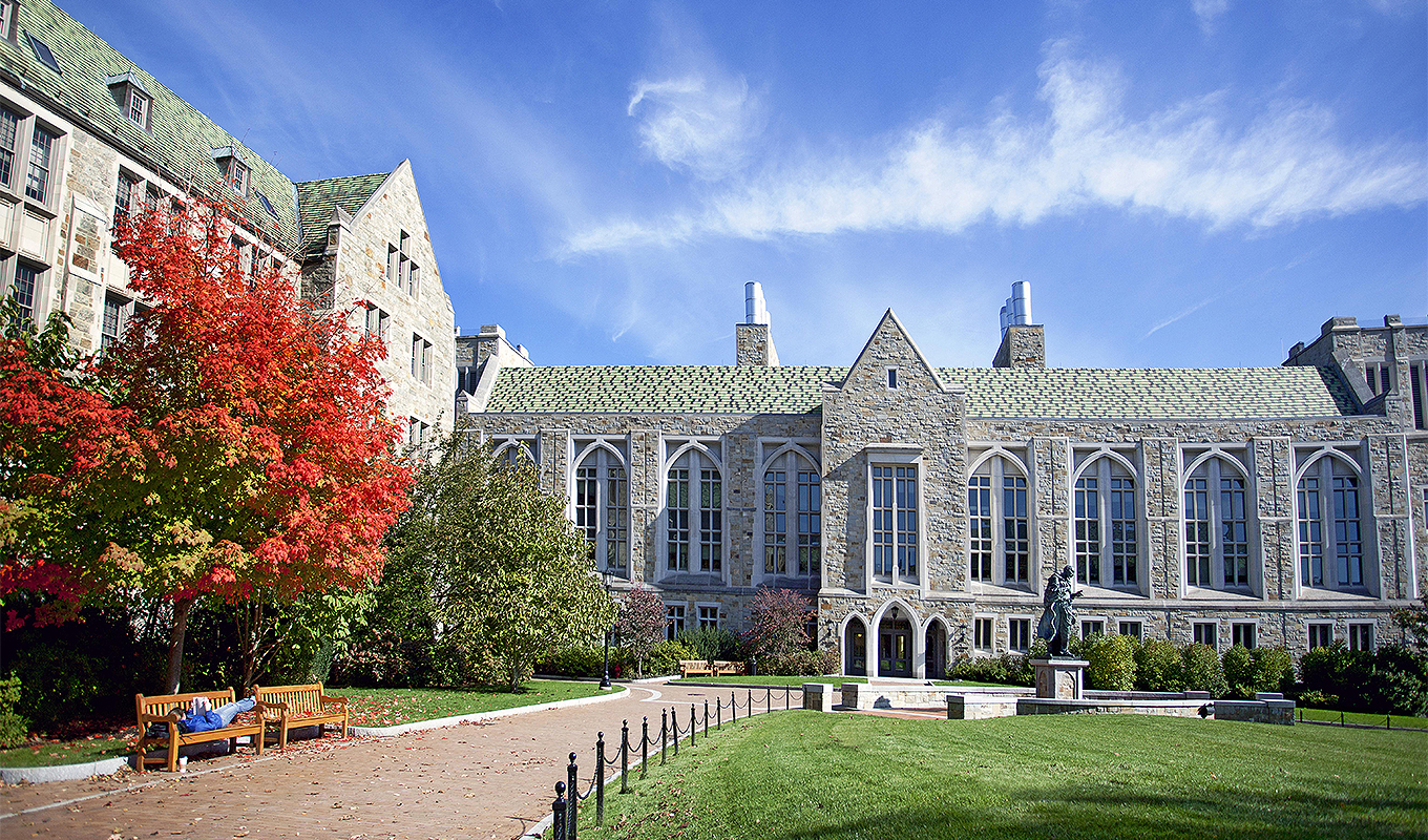 Fall images of the main campus, shot for OMC image library and possible Admissions use.
A female student reads on a bench behind Devlin.