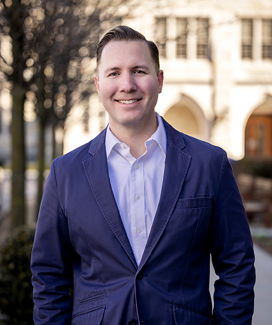 Cal Halvorsen in a blue suit jacket and button down shirt