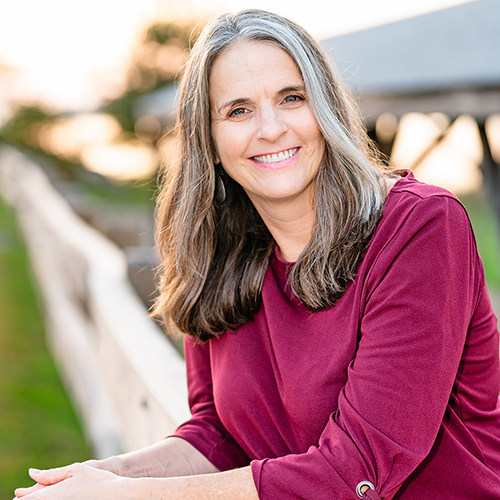 A portrait of Sheilah M. Gauch in a maroon sweater.