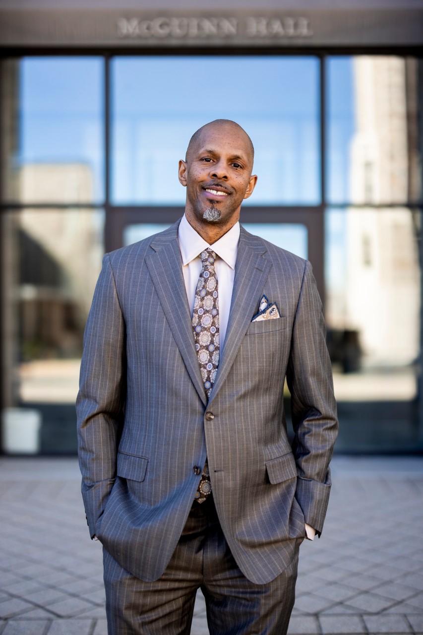 Robert O. Motley Jr. poses for a photo outside of McGuinn Hall.