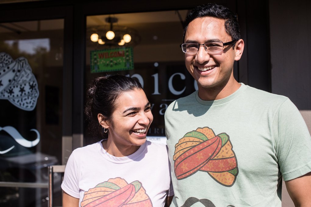 Aakanksha Sinha and Uttam Mukherjee pose for a photo outside their restaurant.