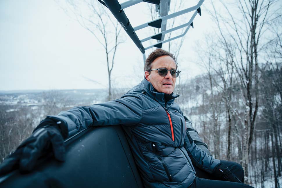 Stephen Kircher seated on a chairlift