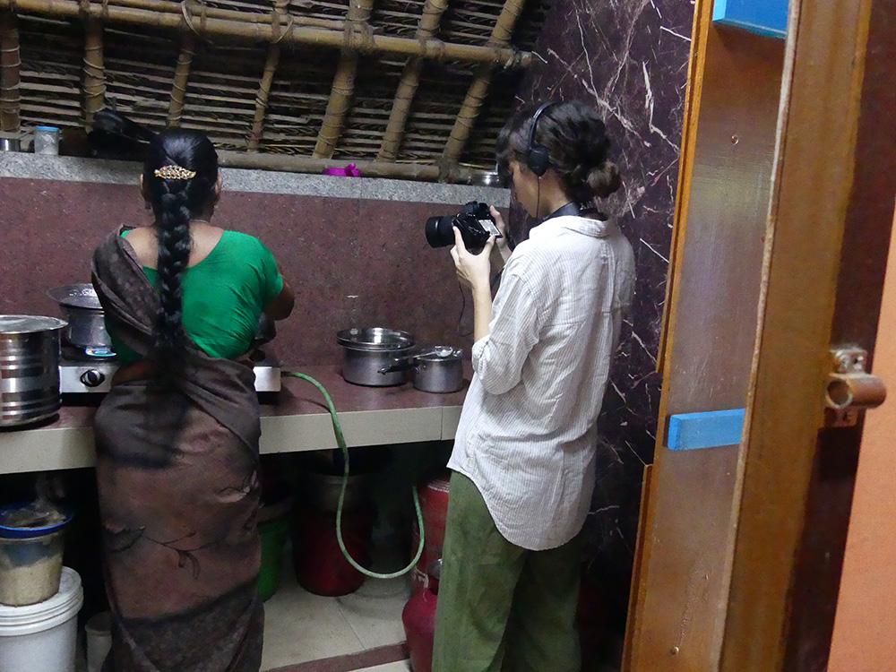 Lola filming a woman inside her home in India