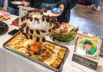 a globe-shaped melon covered with dates on toothpicks