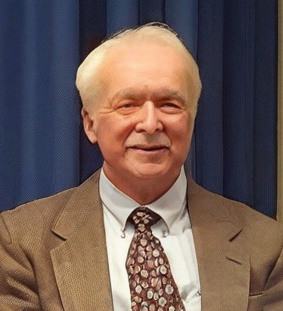 an older man in a jacket and tie